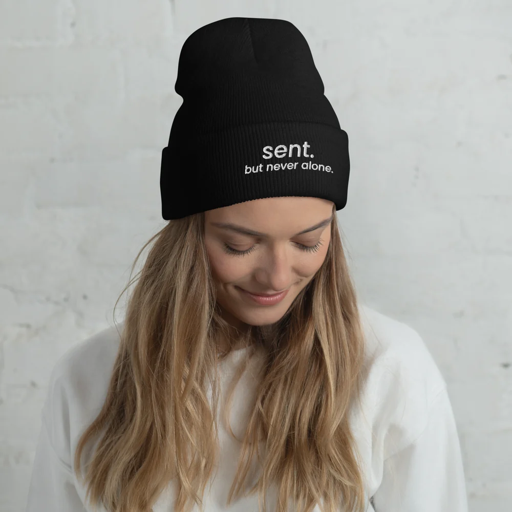 Model wearing the black Sent beanie with white embroidery