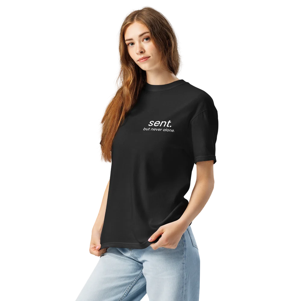 Model wearing the black Sent tee with white lettering