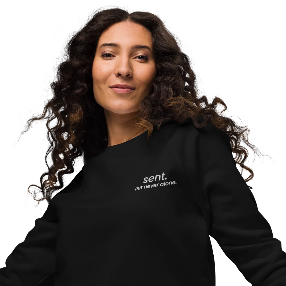 Model wearing the black Sent sweatshirt with white chest embroidery